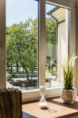 an open window with a view of a park at Central Park Apartments - The Luxury Collection in Kaunas