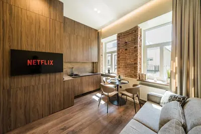 a living room with a couch and a table at Central Park Apartments - The Luxury Collection in Kaunas