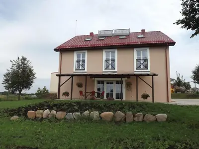 a small house with a red roof at Kaimo turizmas 