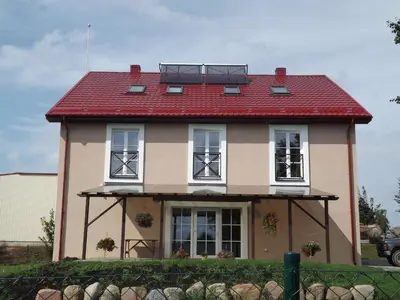 a large house with a red roof at Kaimo turizmas 