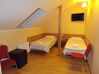 a room with two beds and two chairs at Kaimo turizmas 