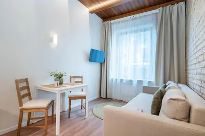 a living room with a couch and a table at Warm studio in the heart of city in Vilnius
