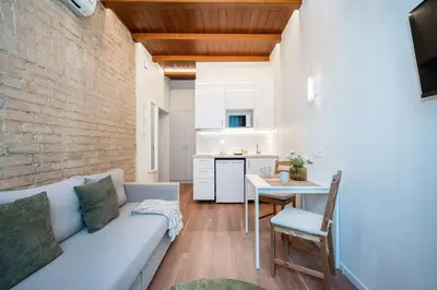 a living room with a couch and a table at Warm studio in the heart of city in Vilnius