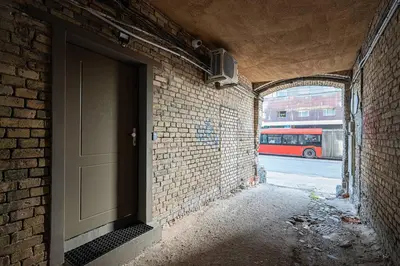 an entrance to a brick building with a door at Warm studio in the heart of city in Vilnius