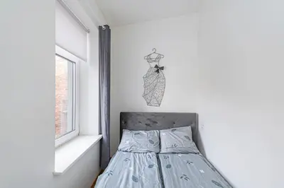 a bedroom with a bed and a window at CityVibe apartment by Polo Apartments in Kaunas