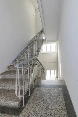 a spiral staircase in a building with a window at CityVibe apartment by Polo Apartments in Kaunas