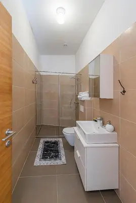a bathroom with a shower and a toilet and a sink at CityVibe apartment by Polo Apartments in Kaunas
