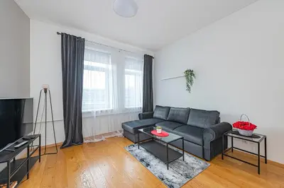 a living room with a couch and a table at CityVibe apartment by Polo Apartments in Kaunas