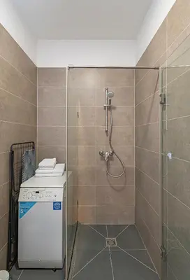 a bathroom with a shower with a glass door at UrbanLife Apartment by Polo Apartments in Kaunas