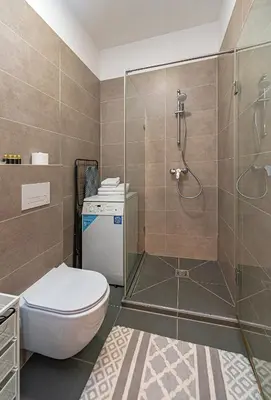 a bathroom with a toilet and a shower at UrbanLife Apartment by Polo Apartments in Kaunas
