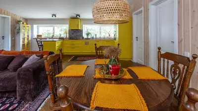 a living room with a table and a couch at Pušyno apartamentai in Druskininkai