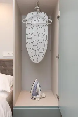 a bedroom with a pendant light and a bed at cohost I Trendy Apt w- Balcony & Garage Parking in Vilnius