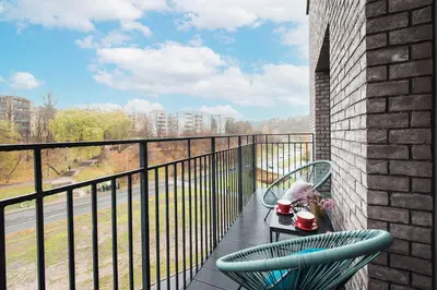 a balcony with two chairs and a table with a view at cohost I Trendy Apt w- Balcony & Garage Parking in Vilnius