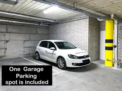 a white car parked in a parking spot is included at cohost I Trendy Apt w- Balcony & Garage Parking in Vilnius