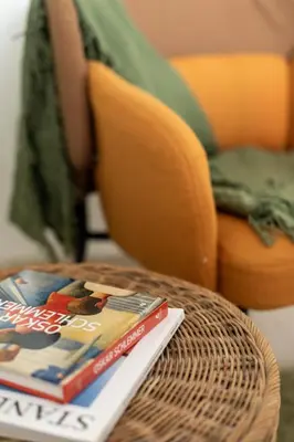 a book sitting on top of a table with a chair at Homey apartment central in Vilnius