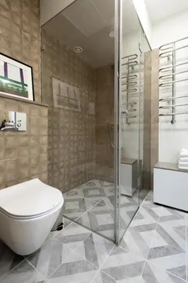 a bathroom with a toilet and a glass shower at Homey apartment central in Vilnius