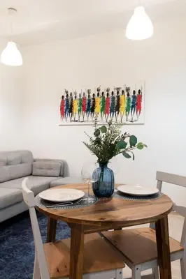 a living room with a table with two chairs and a couch at Homey apartment central in Vilnius