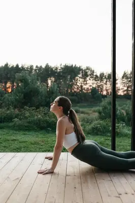 a woman sitting in a yoga pose looking out a window at Konga Stay L in Aluona