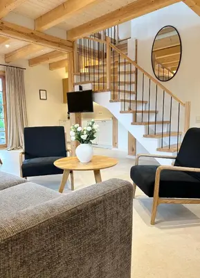 a living room with a couch and a table at Poeto Namas Art in Anykščiai