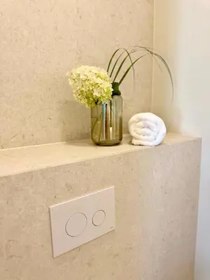 a vase of flowers on a shelf in a bathroom at Poeto Namas Art in Anykščiai