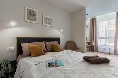 a bedroom with a large bed with a book on it at Amber Apartment Free Parking - Self Check In in Vilnius