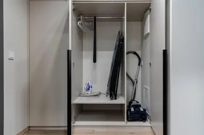 a walk in closet with a glass door and an umbrella at Amber Apartment Free Parking - Self Check In in Vilnius