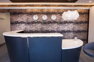 a counter with clocks on a wall at Vila Nikolas in Druskininkai