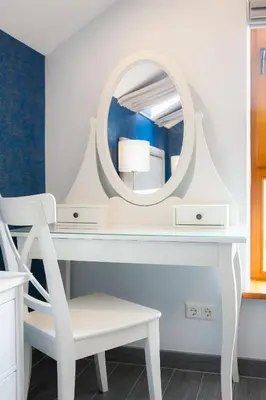 a dressing table with a mirror and a chair at Vila Nikolas in Druskininkai