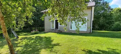 a small house with a yard with a tree at Sodyba Lakaja Sky in Lakaja