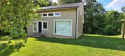a small house in a yard with a grass field at Sodyba Lakaja Sky in Lakaja