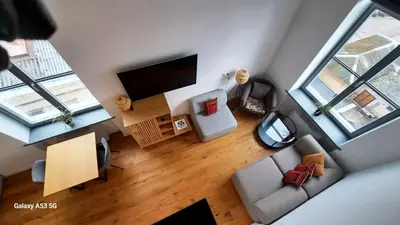 an overhead view of a living room with a flat screen tv at KaunasInn Loft in Kaunas