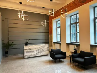a waiting room with two chairs and a wall at KaunasInn Loft in Kaunas