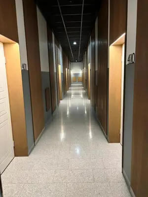 a hallway in a building with a long corridor at KaunasInn Loft in Kaunas