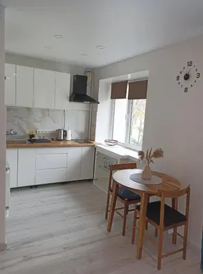 a kitchen with a table and a table and chairs at Vytekstos Apartamentai in Druskininkai