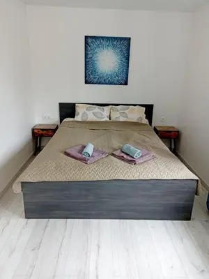 a bed with two towels on top of it at Vytekstos Apartamentai in Druskininkai