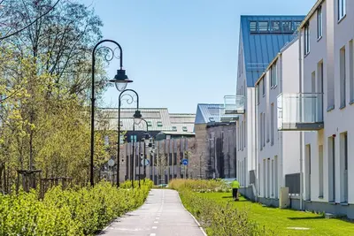 an empty street in a city with tall buildings at Spacious luxury apt w/river view/terrace Paupys in Vilnius