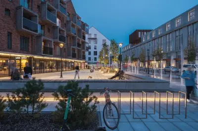 a bike parked on a sidewalk in a city at Spacious luxury apt w/river view/terrace Paupys in Vilnius