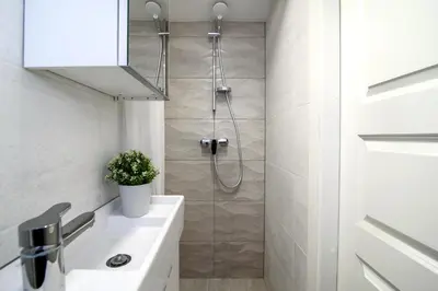 a bathroom with a shower and a sink at Cozy Loft / Near Gates of Dawn / Free Netflix in Vilnius