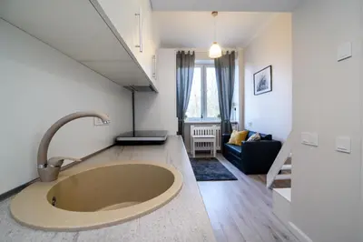 a bathroom with a large tub in the middle of a room at Cozy Loft / Near Gates of Dawn / Free Netflix in Vilnius