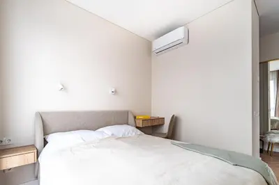 a bedroom with a white bed and a window at Paupys Golden Apartment Vilnius in Vilnius