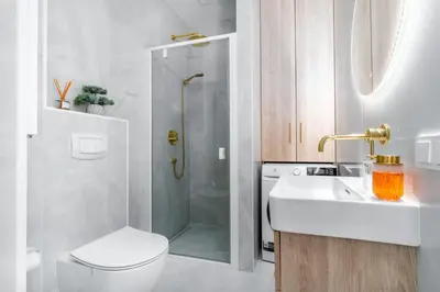 a bathroom with a shower and a toilet and a sink at Paupys Golden Apartment Vilnius in Vilnius