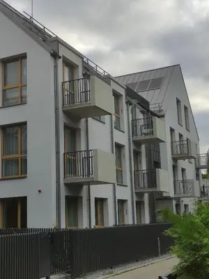 an apartment building with balconies and a fence at Paupys Golden Apartment Vilnius in Vilnius