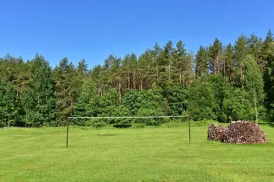 a volley ball net in a field with trees at Pundeliškių sodyba in Šalčininkai