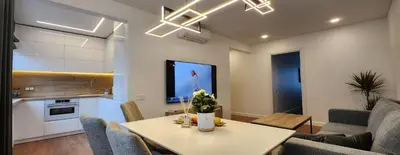 a kitchen and living room with a table and chairs at Golden in Šiauliai
