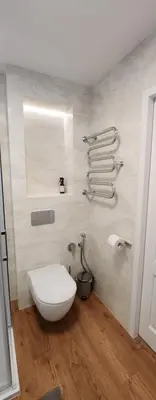 a bathroom with a white toilet and a mirror at Golden in Šiauliai