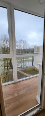 a room with two large windows with a view at Golden in Šiauliai