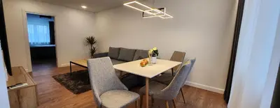 a living room with a table and chairs and a couch at Golden in Šiauliai
