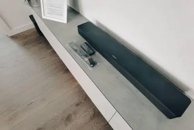 a bench with a remote control sitting on top of it at Brand new apartment in Vilnius center. in Vilnius
