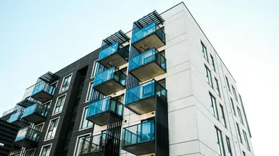 a building with blue balconies on the side of it at Brand new apartment in Vilnius center. in Vilnius