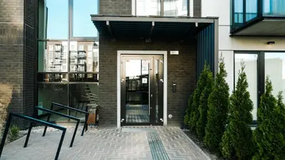 a door to a building with two benches in front at Brand new apartment in Vilnius center. in Vilnius